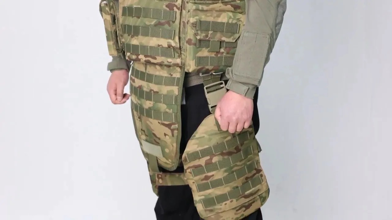 Person wearing a tactical bulletproof vest with leg protection panels in camouflage patternPerson wearing a tactical bulletproof vest with leg protection panels in camouflage pattern