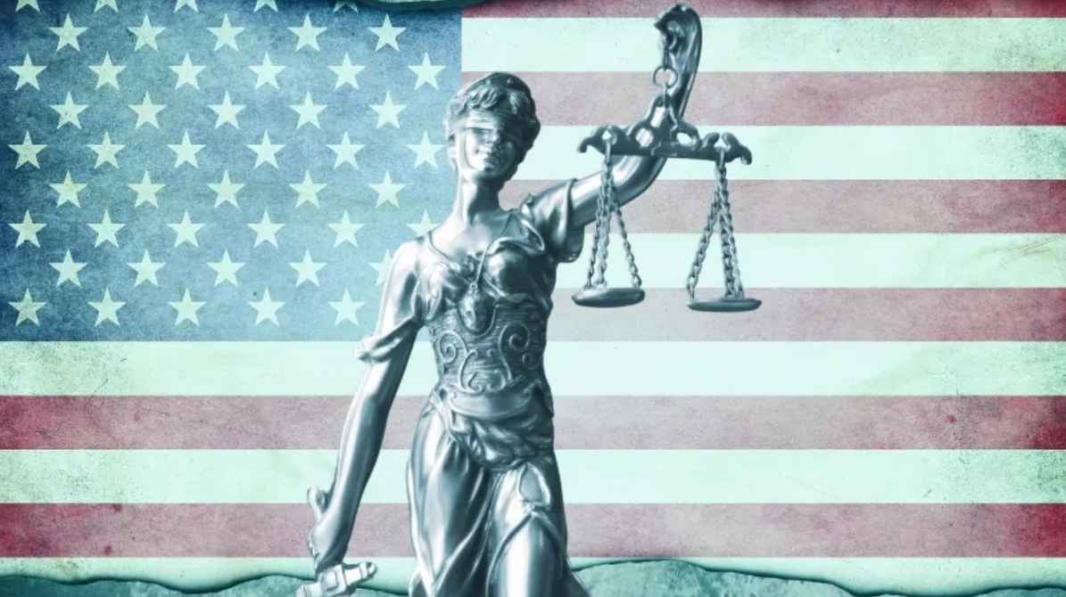 An Image of Lady Justice with Scales in Front of The American Flag