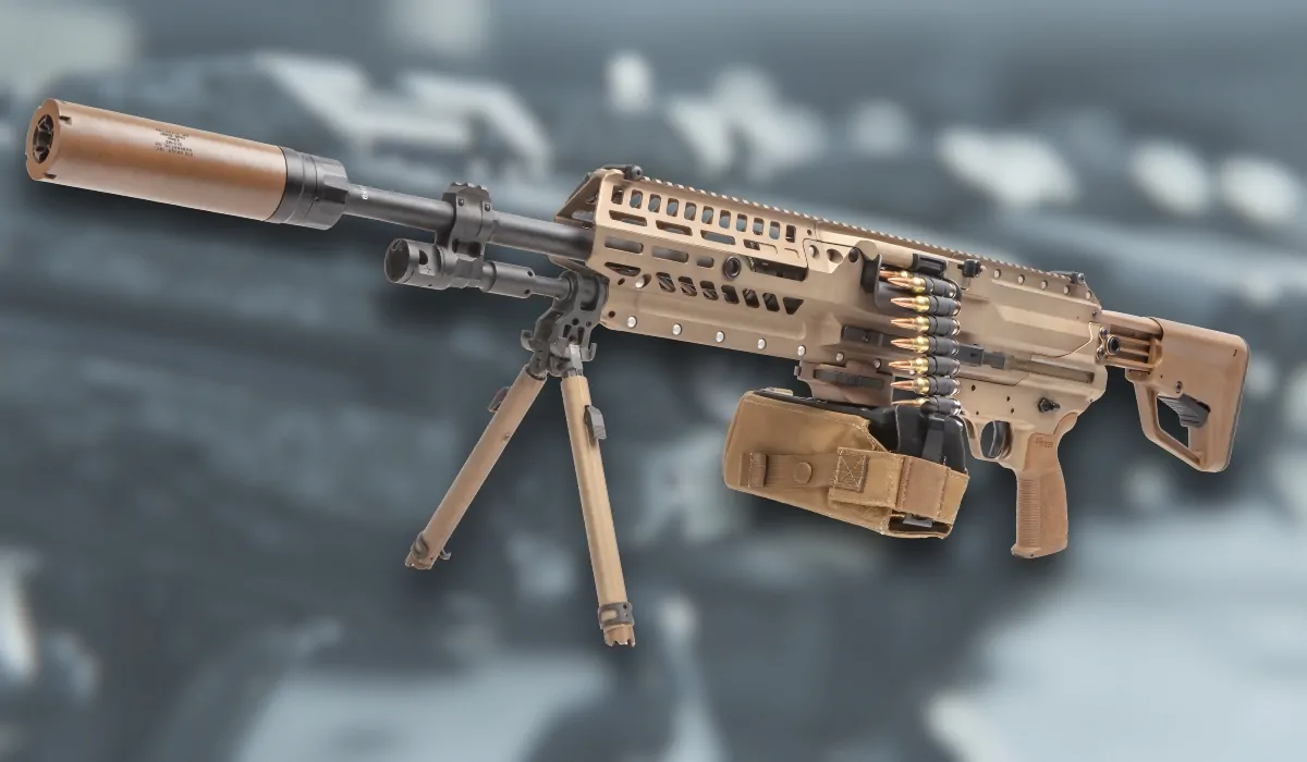 The XM250 automatic rifle with suppressor, bipod, and belt-fed ammunition, shown against a blurred background of firearms