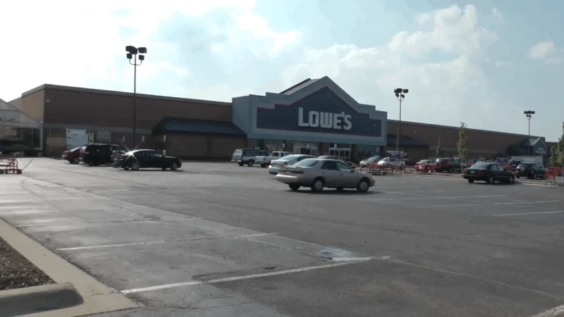 A Lowe’s store with a large parking lot where eligible customers can use the Lowe military discount for home improvement savings