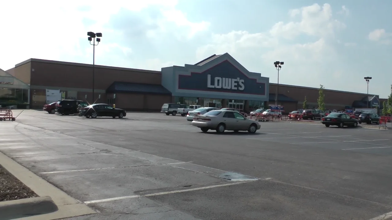 A Lowe’s store with a large parking lot where eligible customers can use the Lowe military discount for home improvement savings