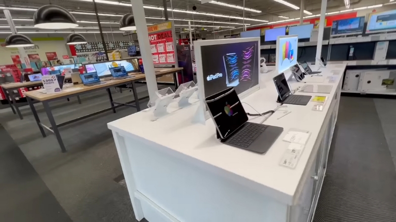 Laptops and tablets displayed inside Staples where seasonal military discounts can help customers save money