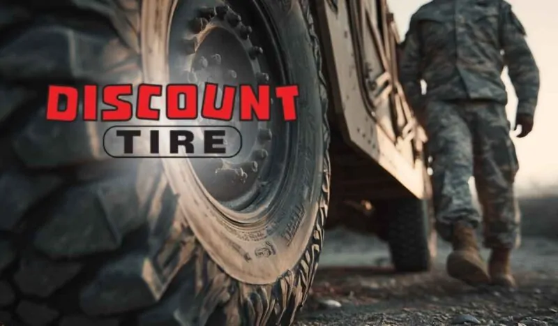 Close-up of a rugged vehicle tire with a soldier standing beside it, overlaid with the Discount Tire logo